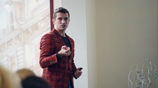 Coach in Formal Wear on Seminar Speaker Giving Presentation Lecture Hall