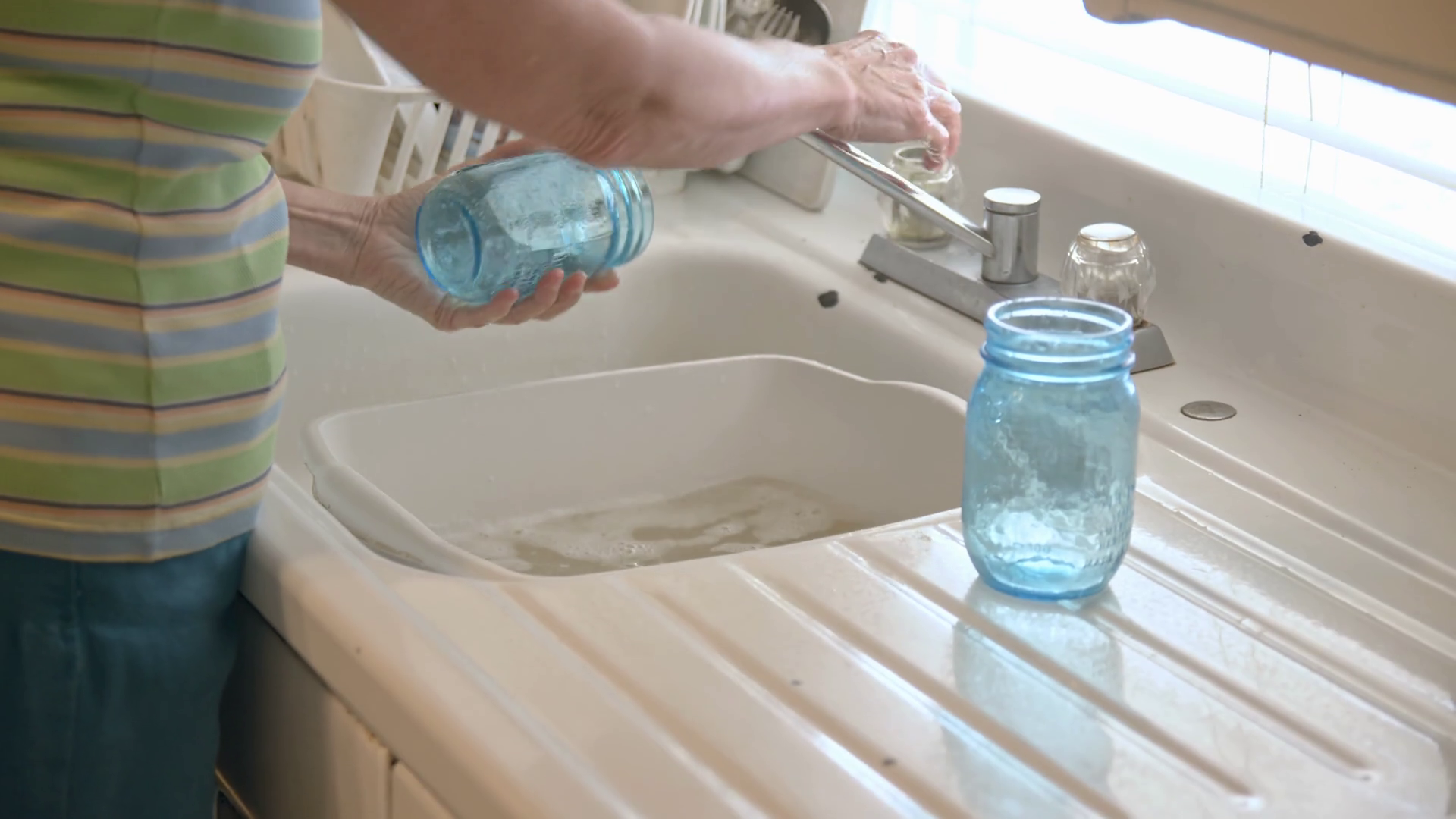 Woman Hand Washing Mason Jars In Kitchen Sink Stock Footage SBV