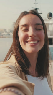 Close up, woman traveler taking selfie on mobile phone while standing in marina