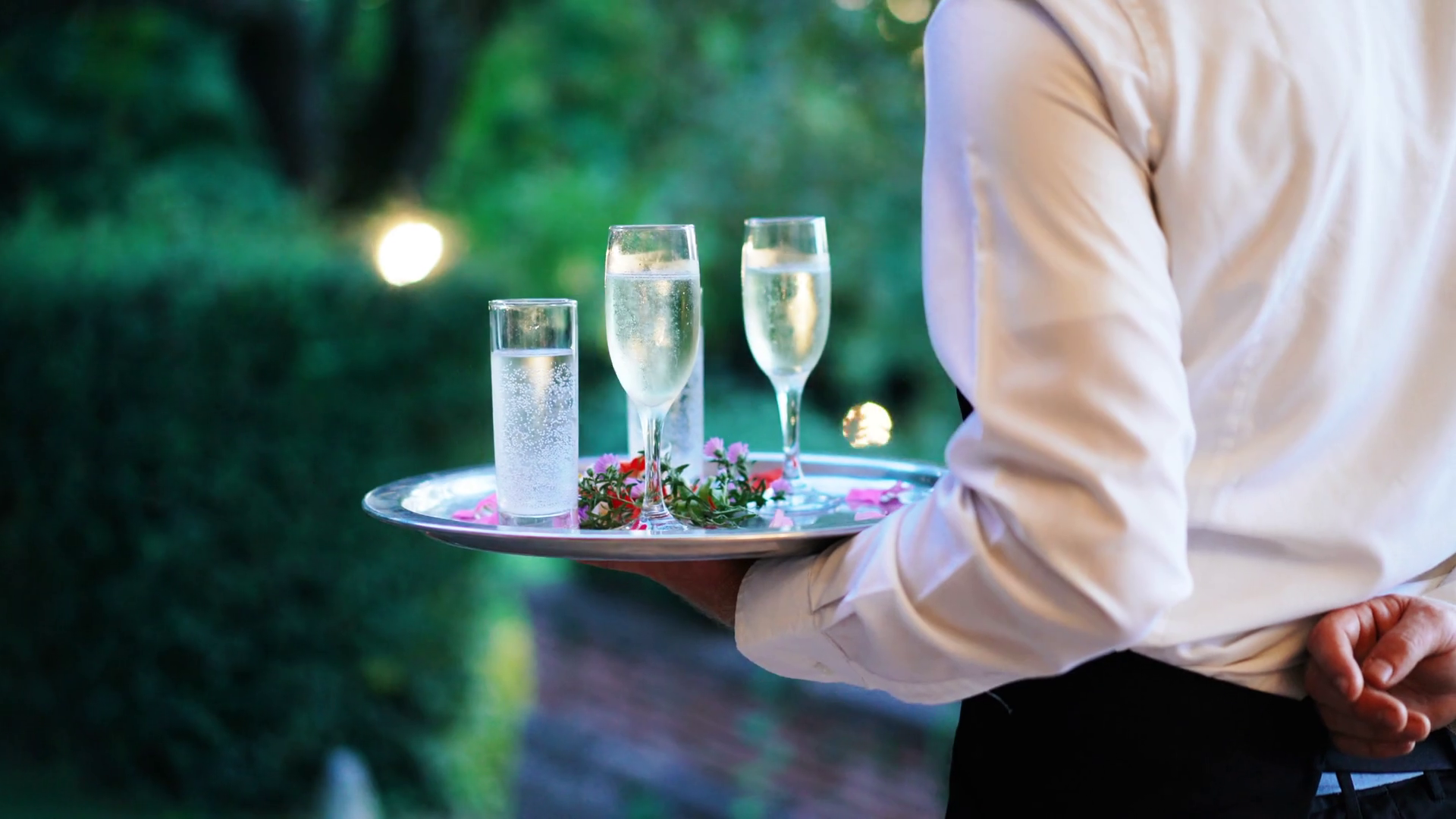 Waiter and champagne glasses on a tray in Luxury Restaurant. Catering service. 4k Stock Video