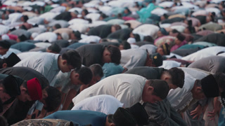 Denpasar, Indonesia - March 21, 2026: Muslim men perform congregational Eid prayer outdoors, capturing unity, devotion, and spiritual atmosphere. Islamic worship, Ramadan, Eid al-Fitr, Eid al-Adha, prayer rituals, and community life.