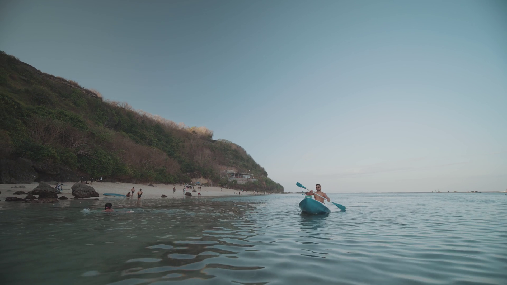 Indonesian Man Canoeing Paddling Canoe at Gunung Payung Beach, Bali