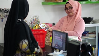 Tarakan, Indonesia. 09092023: Transaction activities between seller and buyer at super market in Tarakan, Indonesia. A customer paying at checkout in supermarket.