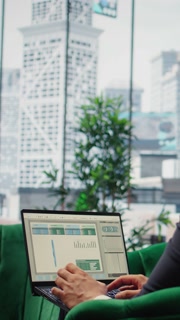 Vertical Video Goals oriented businessman in high end corporate office plans a strategy to ensure company future, reviewing market research