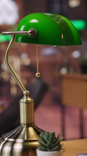 Vertical Video Refined vintage library with wooden shelves and classic green lamps, a calm workspace for booklovers. Empty study area
