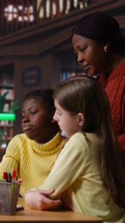 Vertical Video Classmates friends doing a school team project with teacher while on video call webinar, discussing about library books and