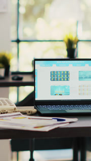 Vertical video Stock market diagrams with charts and stock figures on laptop sitting on desk in empty workplace. Forex investment listings