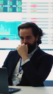 Vertical Video Project manager examining key performance metrics to ensure global business success, working with annual infographics to