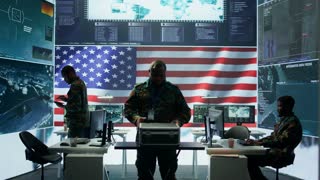 Military officer in a high tech control center engages in cybersecurity operations, protecting data from threats and managing digital