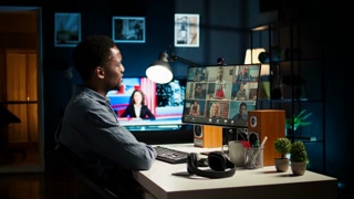Colleagues attending a virtual webinar on pc from their homes, using a laptop for an online meeting call. Young african american man