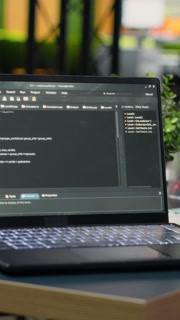 Vertical video Close up of laptop AI program in empty Silicon Valley company office used to optimize systems performance. Notebook in tech