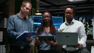 Portrait of engineering team developing artificial intelligence algorithms in high rise office. Teamworking colleagues debug 3D neural