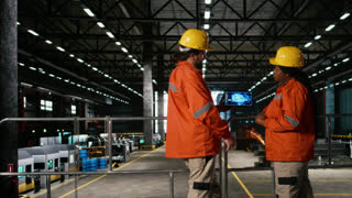 Engineers team analyzes AI brain interface inside heavy industry factory warehouse, AI-powered visualization uses machine learning and cloud