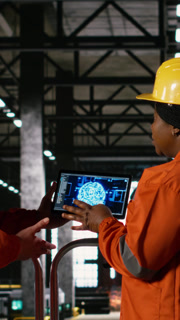 Vertical Video Two staff members examine artificial intelligence visualization of AI brain, emphasizing machine learning to aid in large