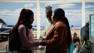 Supportive parents and teenage child in sad goodbye at the airport terminal, the pain and pride of sending young solo traveler to study