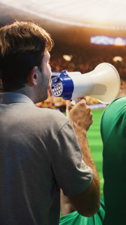 Vertical video Close up of man yelling through in soccer stadium stands to cheer players. Rear view of loud fan animating sports arena