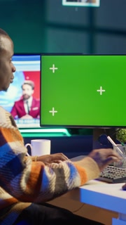 Vertical Video African american advisor reviewing legal balance at his desk next to green screen, examining capital funds statistics for