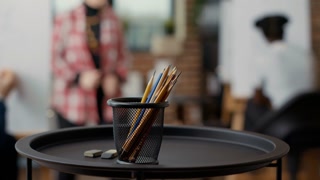 Artistic tools and colorful pencils on table in art class workshop, using instruments to create drawing model and to develop creative skills. Development school program. Close up. Handheld shot.