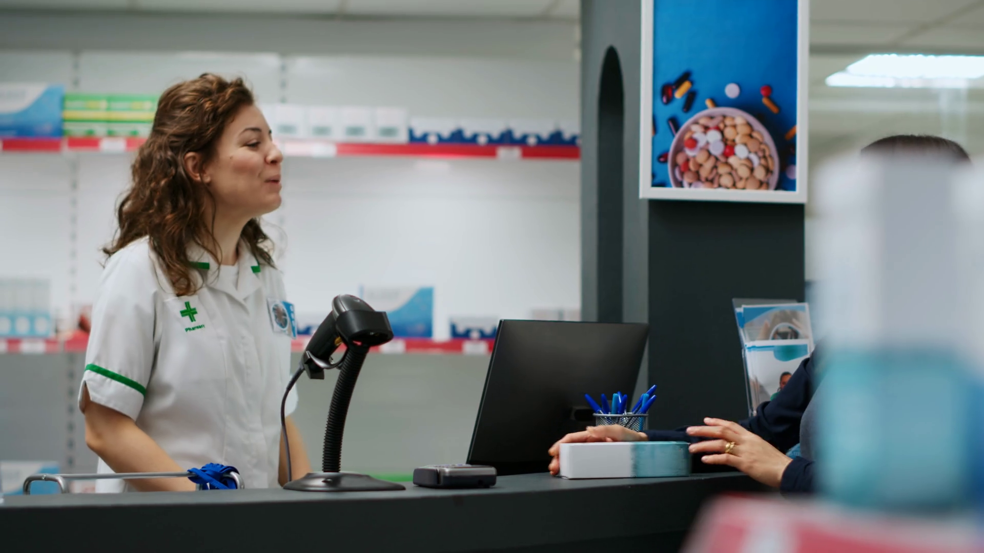 Female pharmacist helping clients to buy medical products, scanning
