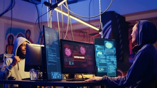 Hackers in hidden shelter excited after managing to launch successful DDoS attack on website, celebrating being able to it crash by sending