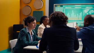 Startup team review financial reports and performance metrics on laptop, using sales statistics and infographics for annual data reports