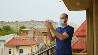 Cheerful man with mask clapping