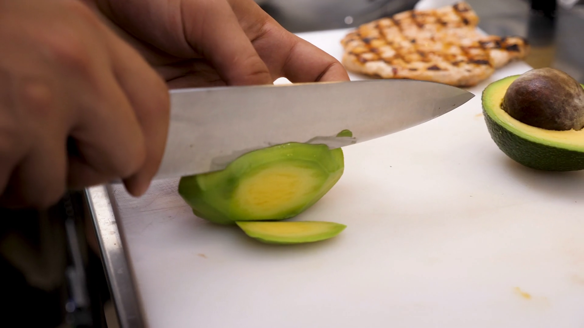 Chief Cutting Avocado On Board In Kitchen Stock Footage SBV327860777