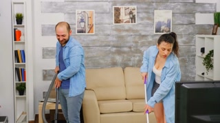 Cleaning routine for a young couple in their new home. Medium-paced shot