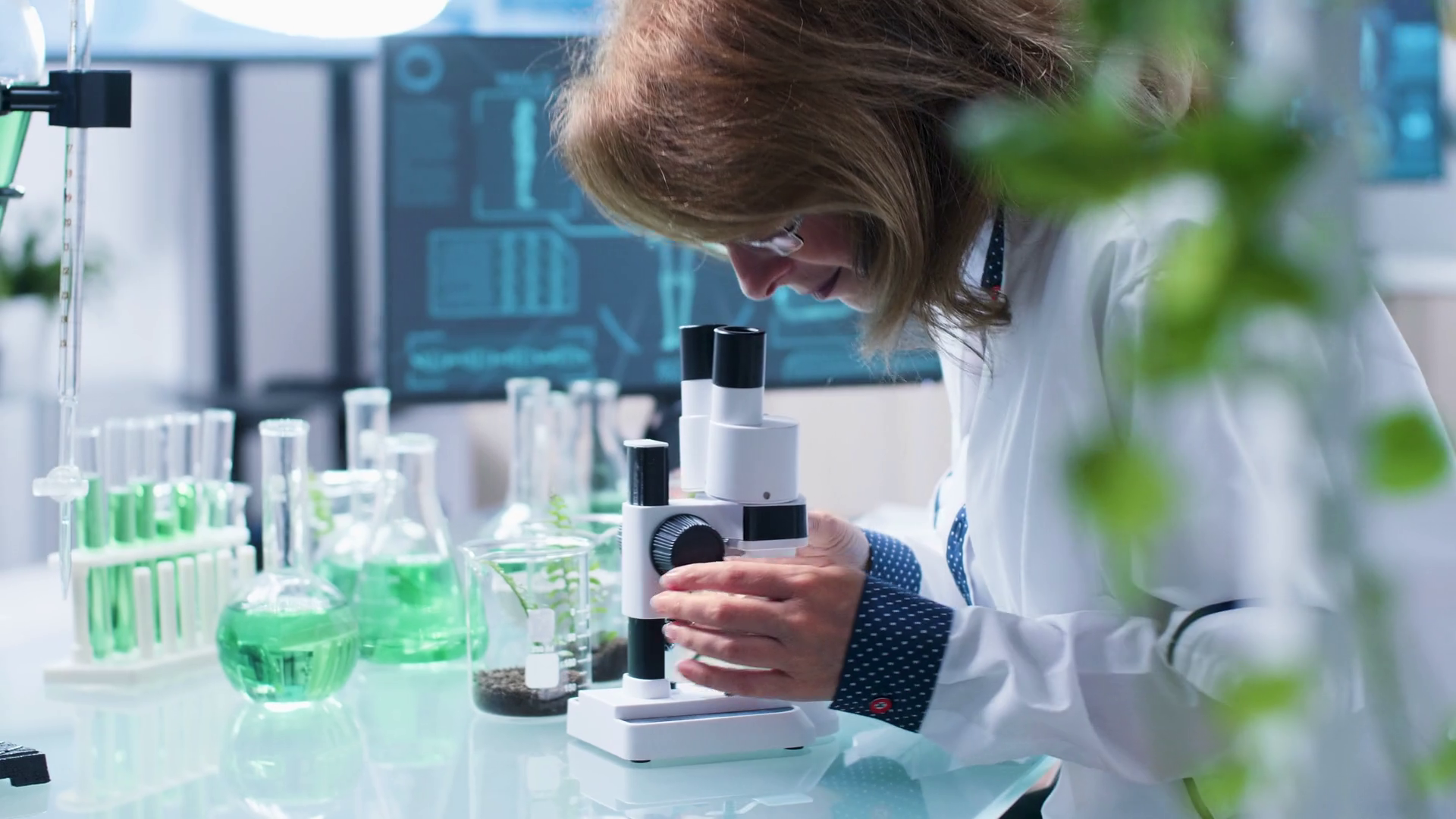 Close up shot of bio chemist desk using a microscope to look at samples