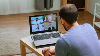 Man talking business strategy on video call during a webinar in time of global pandemic.