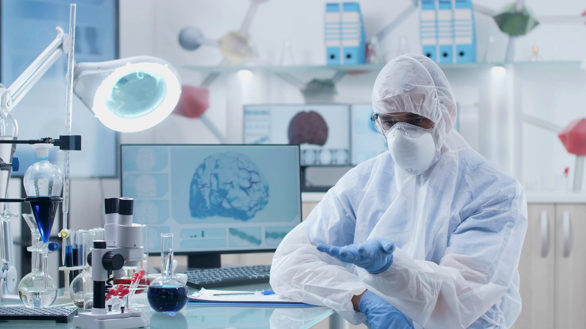 Scientist wearing AR glasses looks and learng through augmented reality