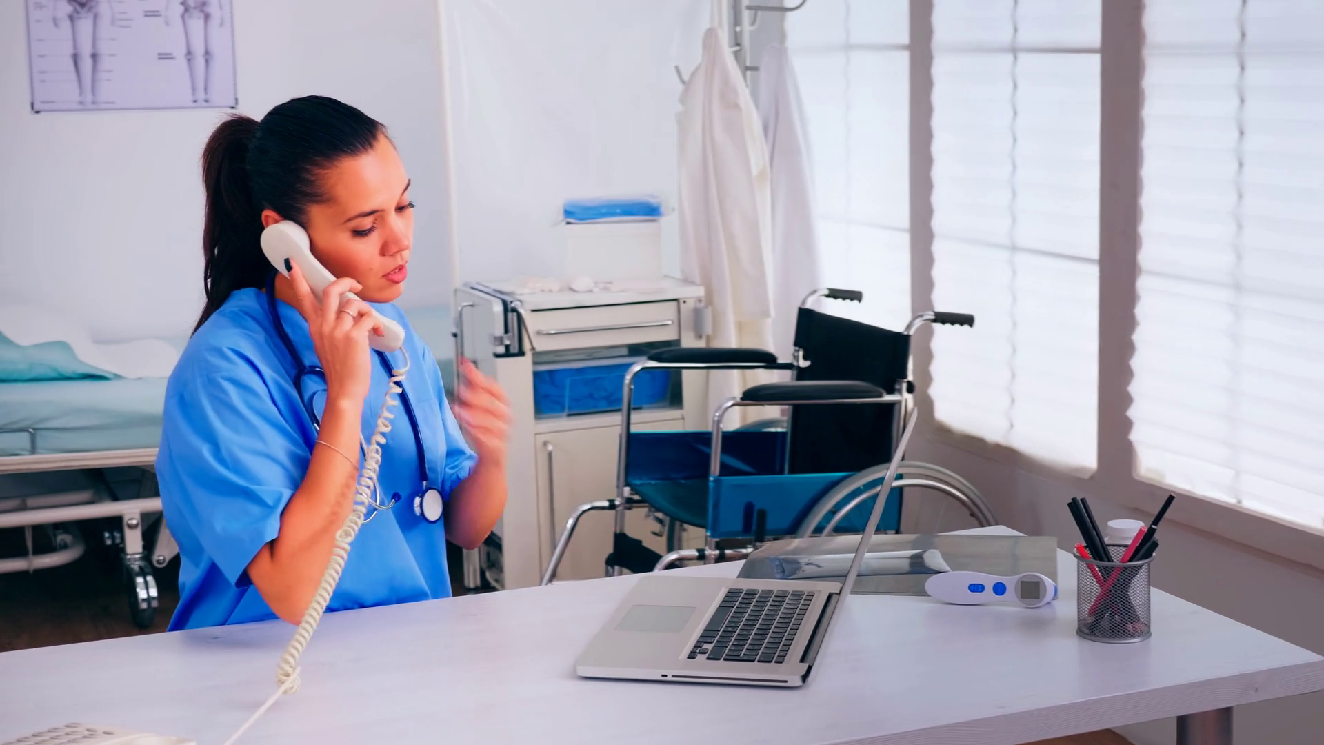 Specialist radiologist analysing patient radiography holding it during telehealth discussion