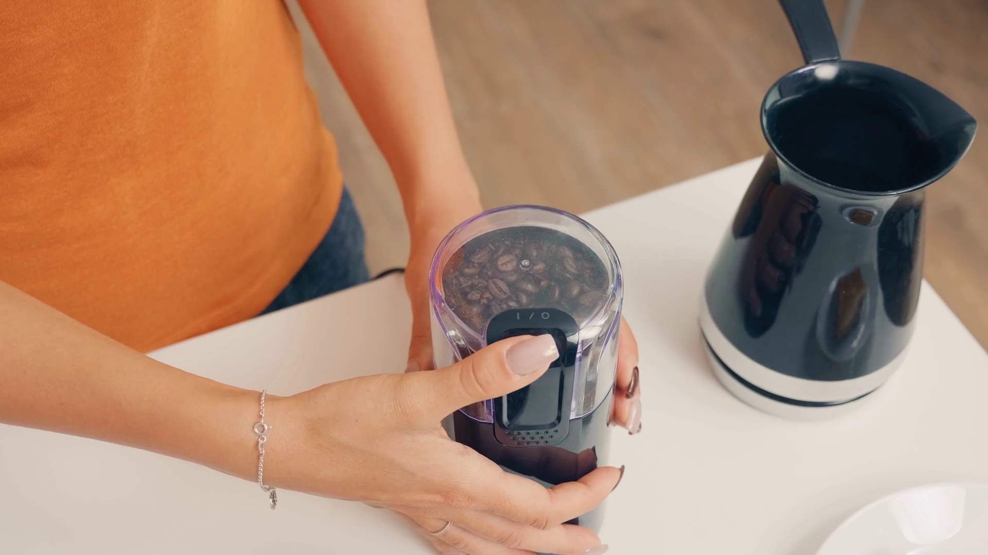 Woman grinding roasted coffee beans. Housewife at home making fresh