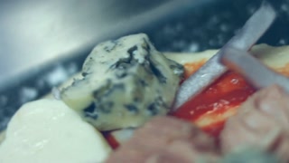 Smoke transformation effect of Spreading parmigiano cheese over pizza dough with other ingredients. Preparing heart shaped tuna pizza for Valentine's Day for a loved one. 4K video