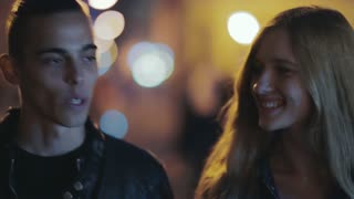 Young couple enjoying a pleasant evening stroll in the city. Heartwarming moment captured.