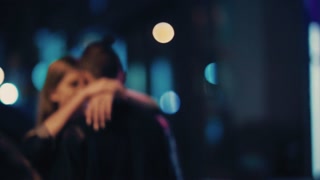 Embracing couple kissing in city lights at night. Happy together, romance, date. Love story.