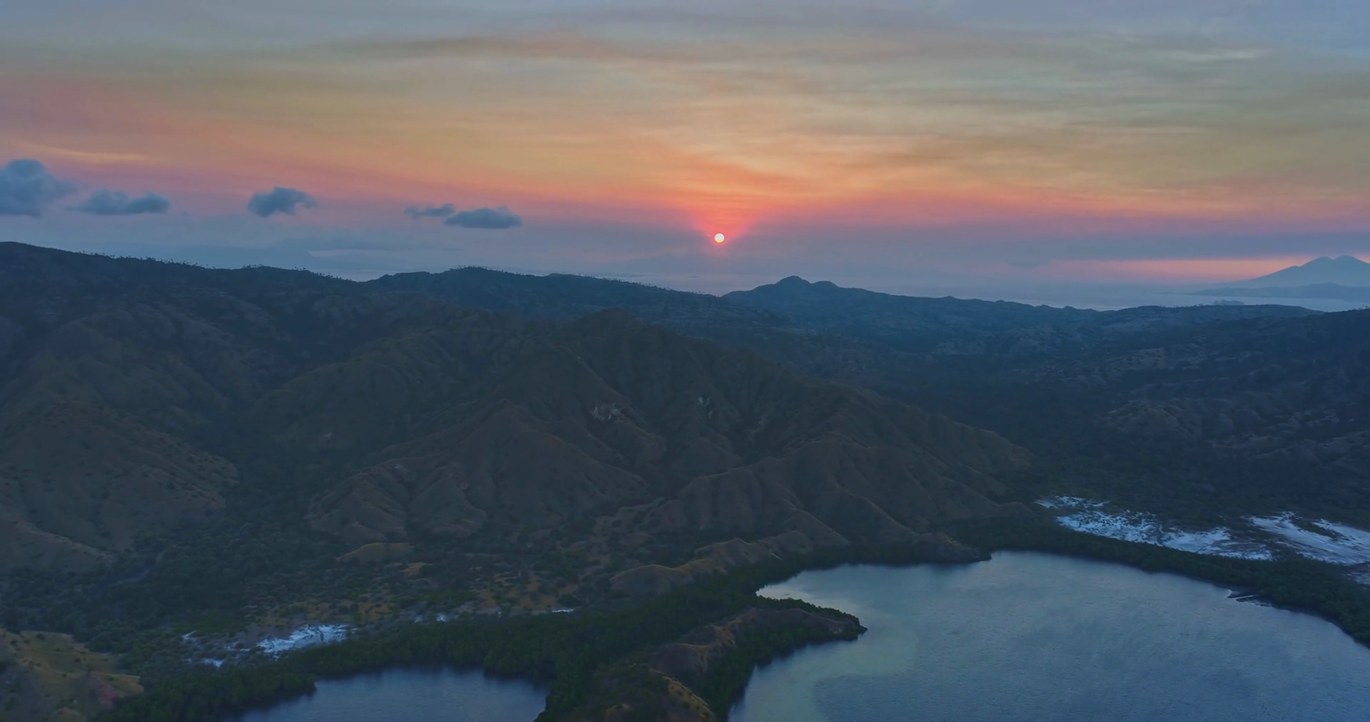 The Setting Sun Casts Warm Glow Over Rugged Stock Footage SBV-351917859 ...