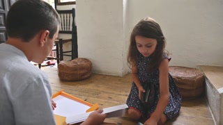 Children preparing for back to school with books and supplies in a cozy home environment, promoting learning and education readiness