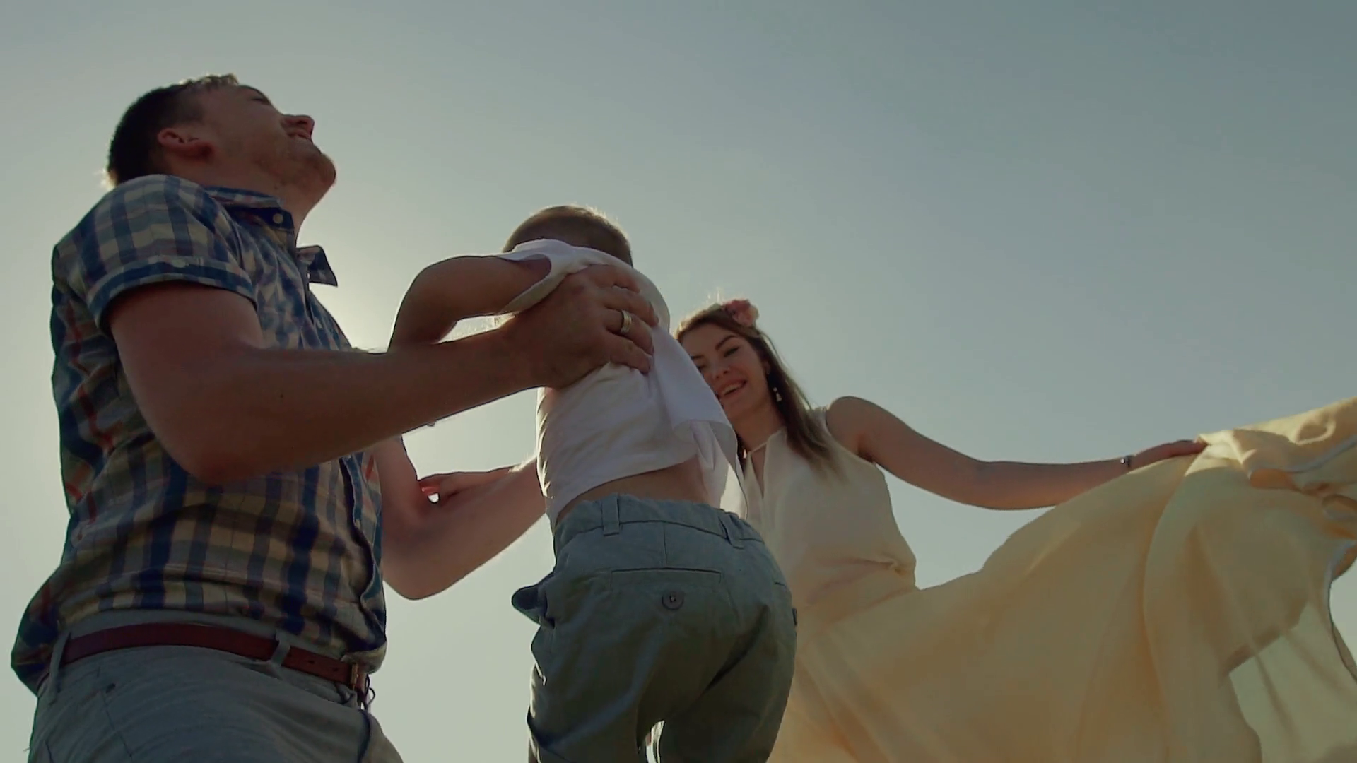 Closeup of young father throwing his child in the air and catches him Stock Video Footage 0014