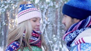 Close-up of affectionate couple embracing in winter forest
