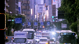TOKYO, JAPAN, MARCH 1978. Ginza, Chuo Ko Prefecture. Pan Over Busy Shopping Street With Traffic
