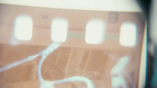 Viewing Street Scene On 35Mm Film Negative With Loupe, close up