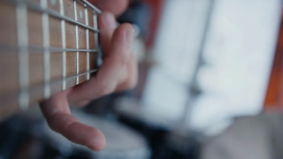 POV Close up of guitarist hand playing on guitar. Close up shot