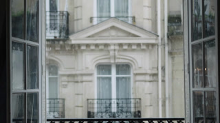 Rain falling outside apartment window in paris