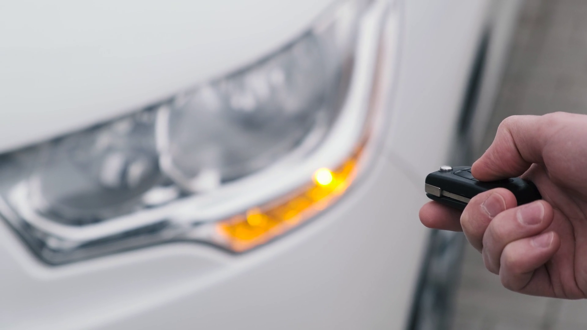 Unlocking the car by the car's key remote control with flashing car headlight Stock Video