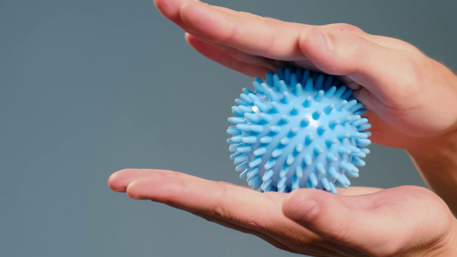 Man Massaging Palms With Prickly Massage Ball Stock Footage SBV