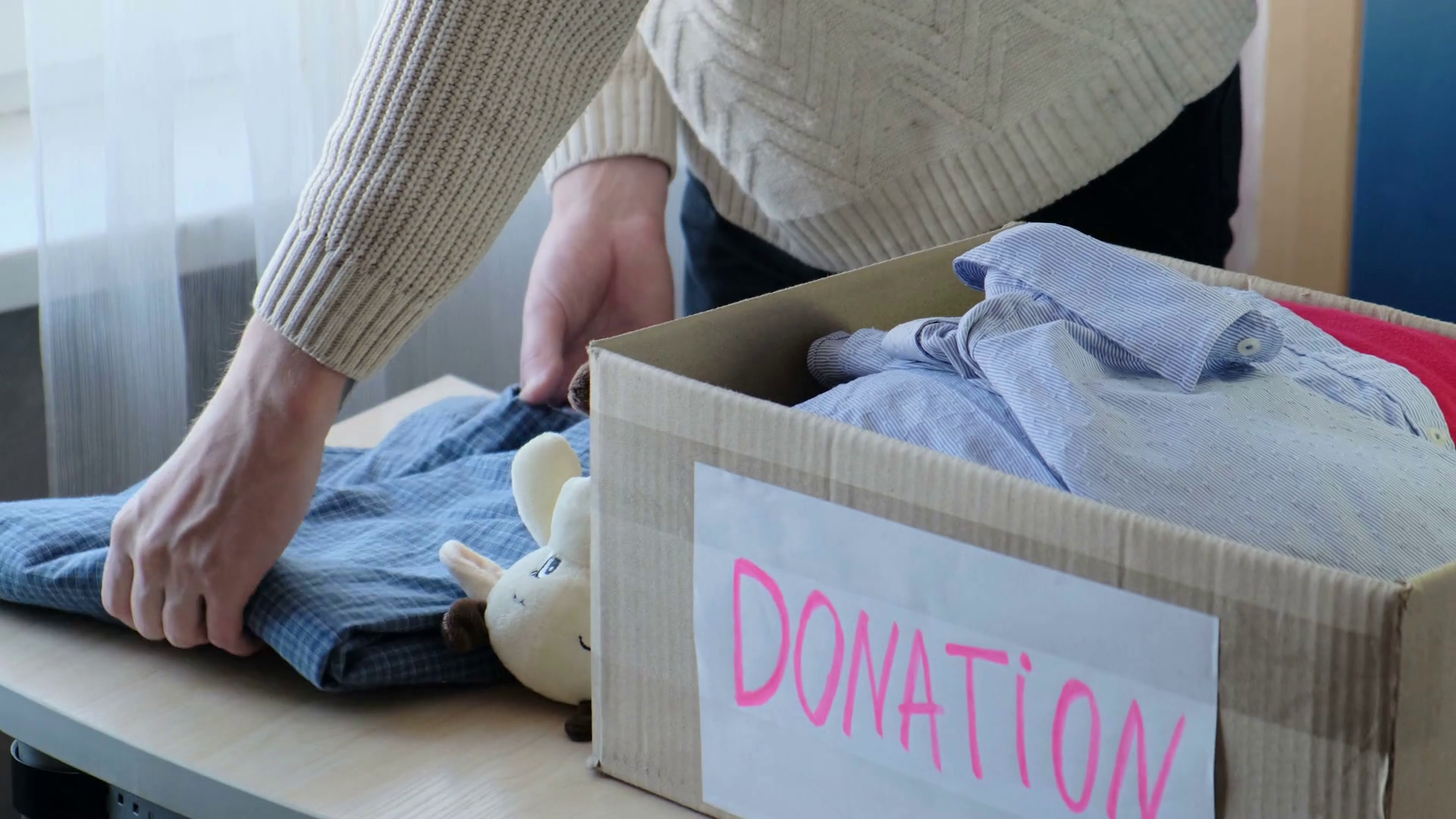 A Man Packs Clothes Donation Charity Stock Footage SBV338137962