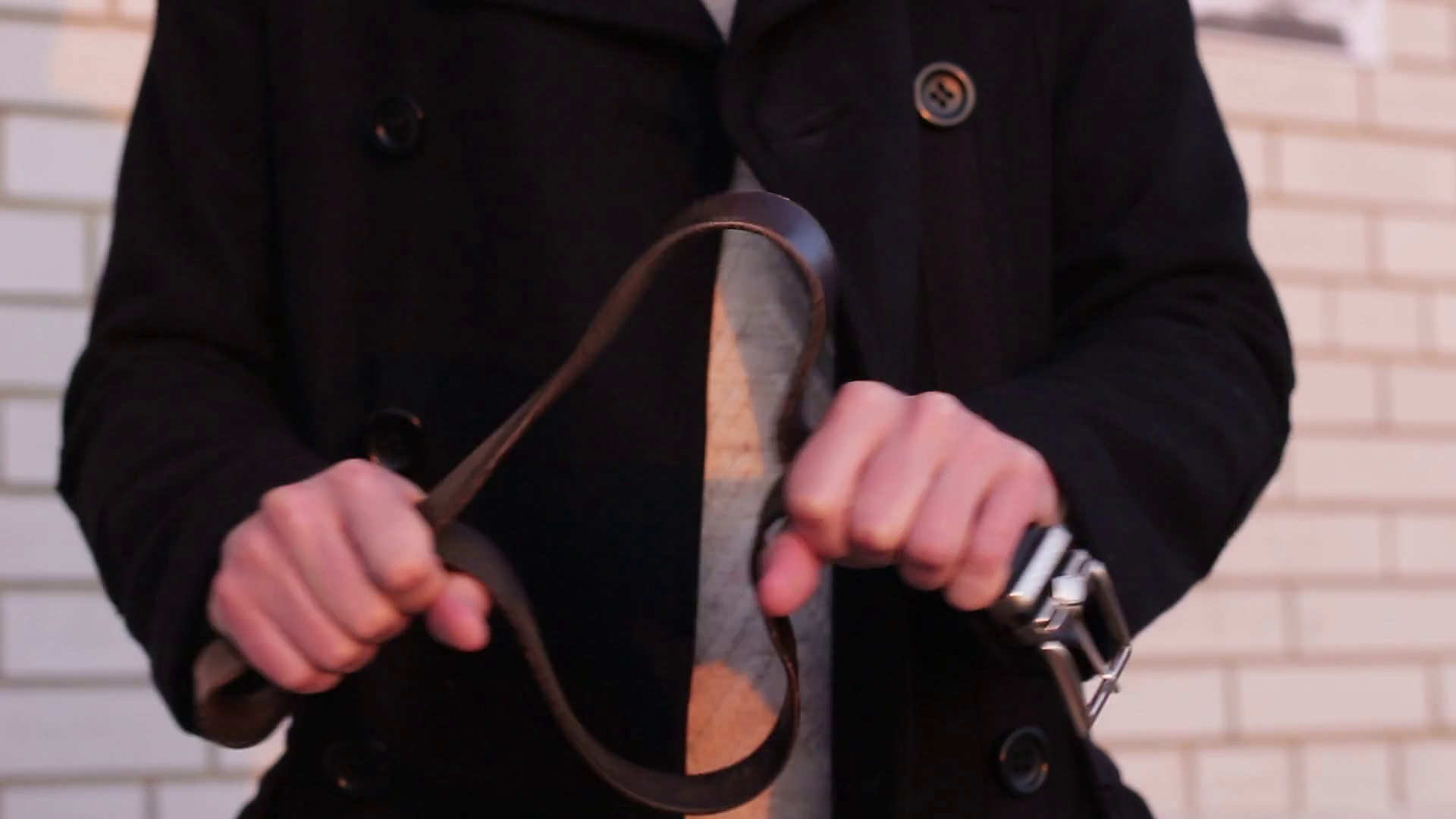 Belt in the hands of a man before punishing a child close up Stock