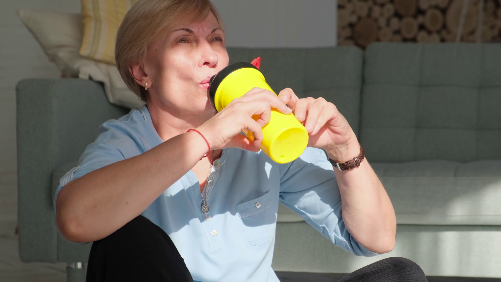 Elderly woman drinking protein shake after workout at home Stock Video