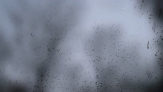 A Stylized depiction of raindrops falling on the  windshield of a moving car